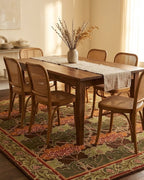 Cesil Floral Wool Rug in Green under a dining table