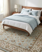Malicka Persian-style wool rug under a bed