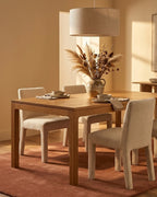 Liso Mocha Mousse solid hand-tufted wool rug under a dining table