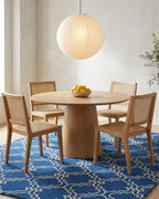 Scroll Tile Moroccan wool rug in blue and ivory under a dining table
