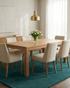 Liso Teal solid hand-tufted wool rug under a dining table