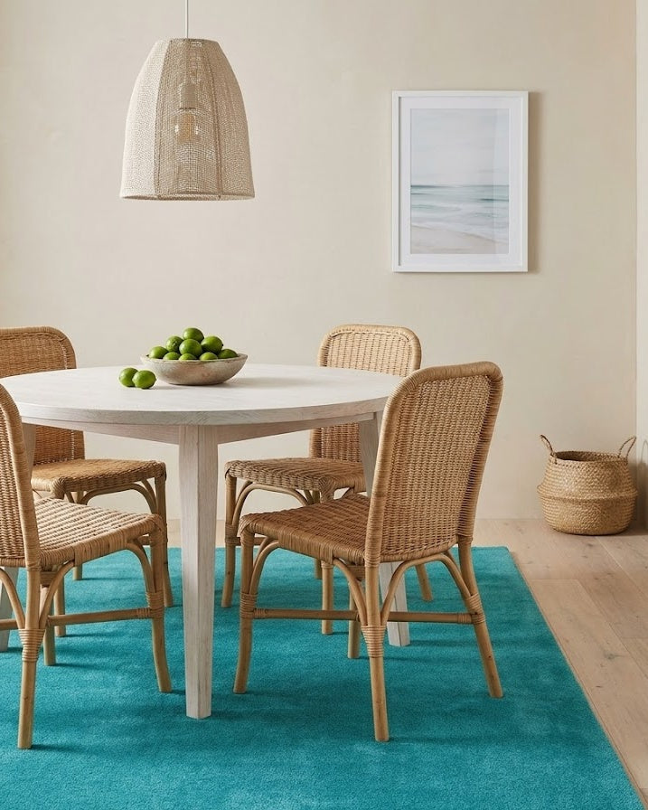Liso Turquoise solid hand-tufted wool rug in a coastal dining room